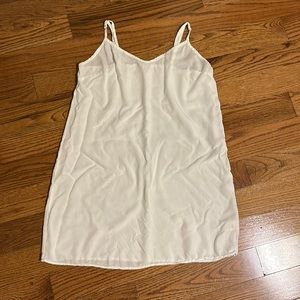 White slip 100% cotton. Loose fit